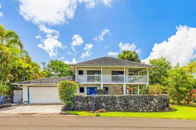 5611 Ohelo Rd, Kapaa, HI 96746 - view of front facade featuring a garage, a balcony, and driveway