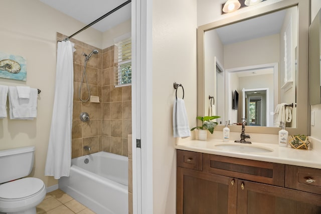 full bath featuring tile patterned flooring, vanity, shower / tub combo, toilet, and baseboards