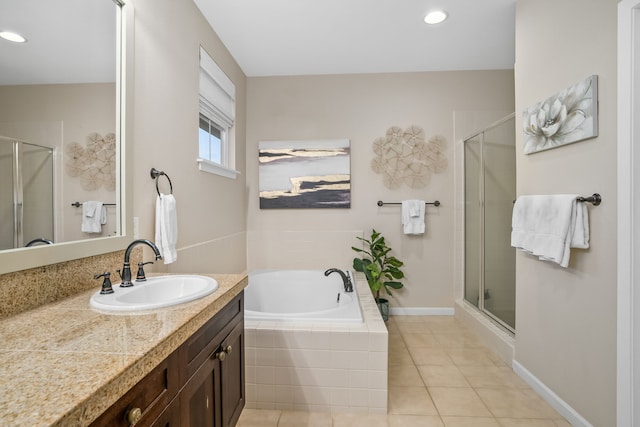 bathroom with vanity, baseboards, a shower stall, tile patterned floors, and a bath