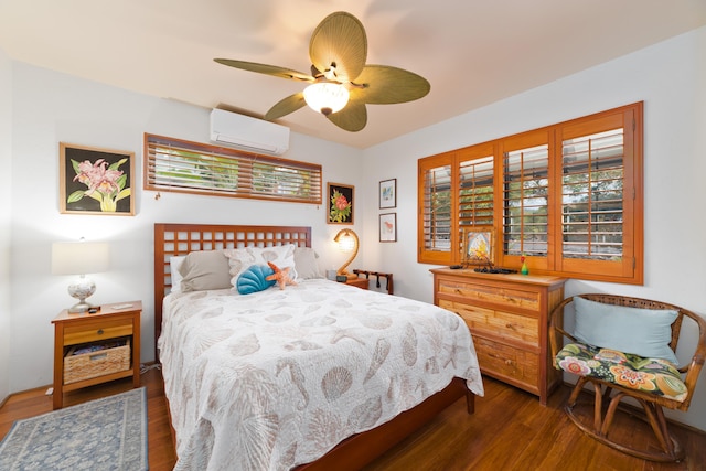 bedroom with an AC wall unit, ceiling fan, multiple windows, and wood finished floors