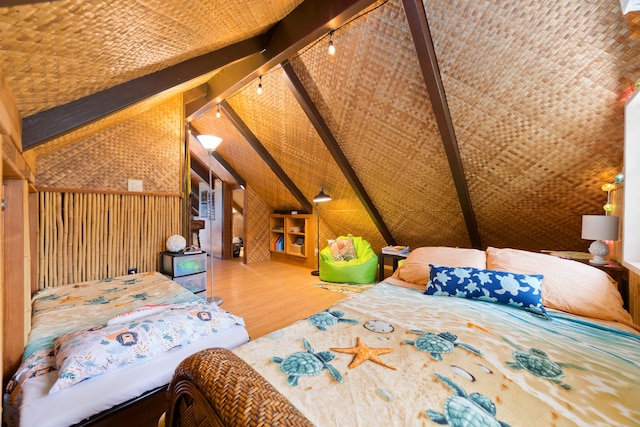 bedroom with wood finished floors, wooden walls, and lofted ceiling with beams