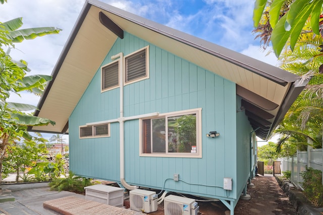 view of home's exterior with fence and ac unit