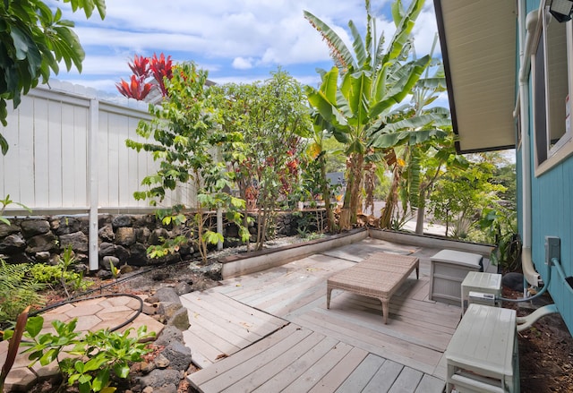 wooden deck with a fenced backyard
