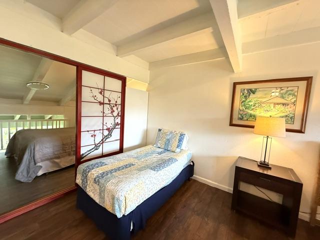3880 Wyllie Rd Unit 8C, Princeville, HI 96722 - bedroom featuring beam ceiling, wood finished floors, and baseboards