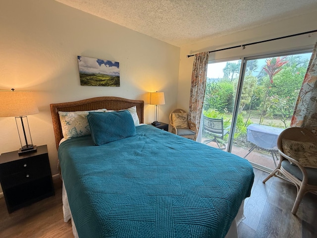 3880 Wyllie Rd Unit 8C, Princeville, HI 96722 - bedroom with access to exterior, wood finished floors, and a textured ceiling
