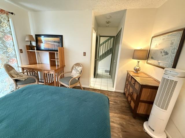 3880 Wyllie Rd Unit 8C, Princeville, HI 96722 - bedroom with wood finished floors and baseboards