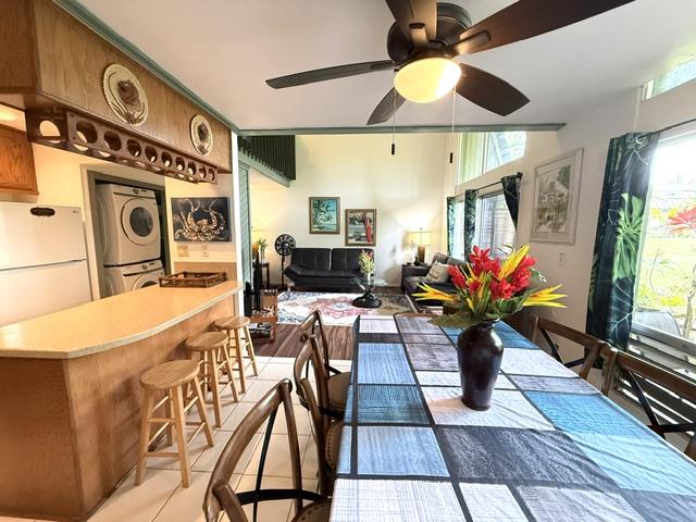 3880 Wyllie Rd Unit 8C, Princeville, HI 96722 - dining room with stacked washer and clothes dryer, plenty of natural light, ceiling fan, and a dry bar