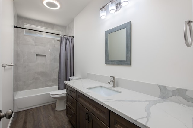 bathroom with shower / bath combo, wood finished floors, toilet, and vanity