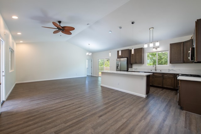 kitchen with a kitchen island, appliances with stainless steel finishes, open floor plan, and a healthy amount of sunlight
