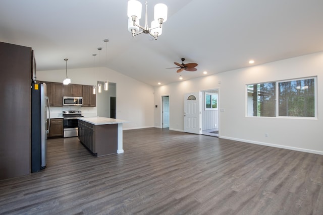 kitchen with stainless steel appliances, light countertops, dark wood-style floors, open floor plan, and vaulted ceiling