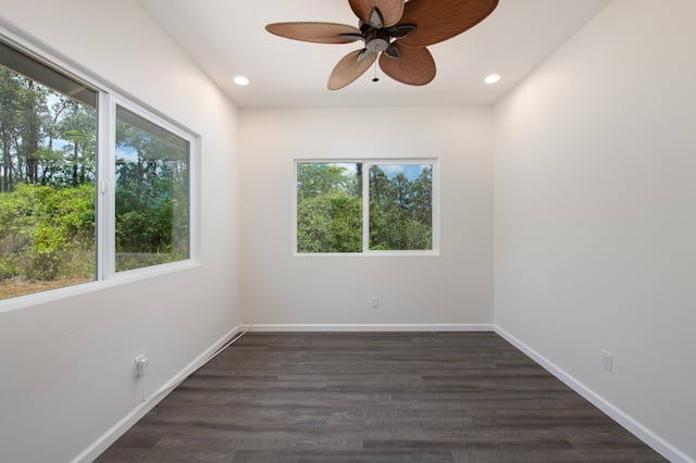 unfurnished room featuring recessed lighting, ceiling fan, a wealth of natural light, and dark wood-style flooring