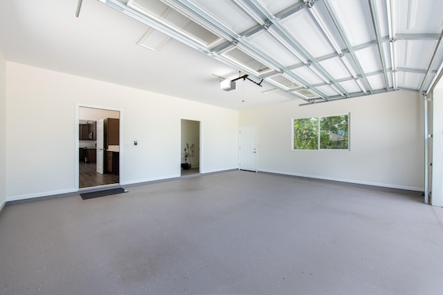 garage featuring a garage door opener and baseboards