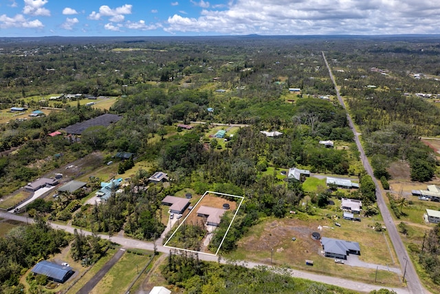 drone / aerial view featuring a wooded view