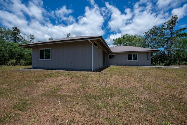 rear view of property with a yard