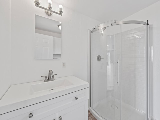 full bath with vanity and a stall shower