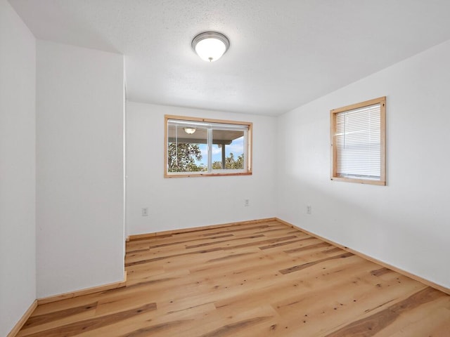 spare room with wood finished floors