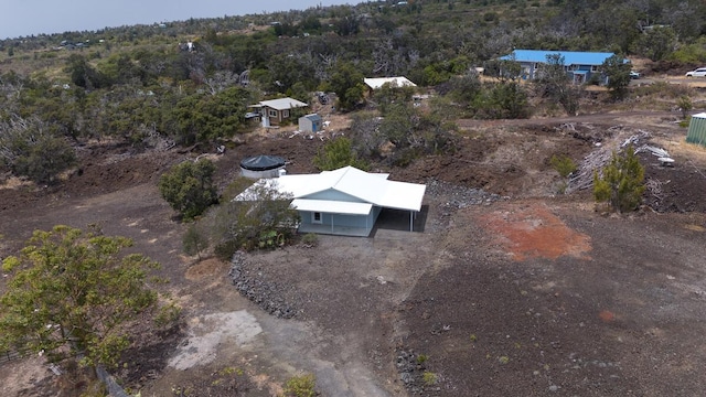 drone / aerial view featuring a wooded view
