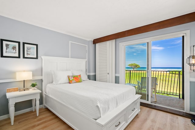 4331 Kauai Beach Dr Unit 4113, Lihue, HI 96766 - bedroom with baseboards, a water view, access to outside, and light wood-type flooring