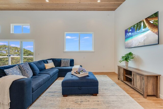 living room with baseboards, recessed lighting, light wood-type flooring, and wooden ceiling