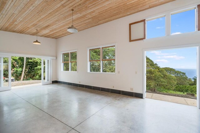 unfurnished room featuring wood ceiling, finished concrete floors, and plenty of natural light
