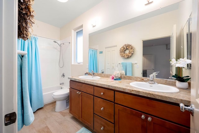 bathroom featuring double vanity, toilet, a sink, and shower / tub combo with curtain