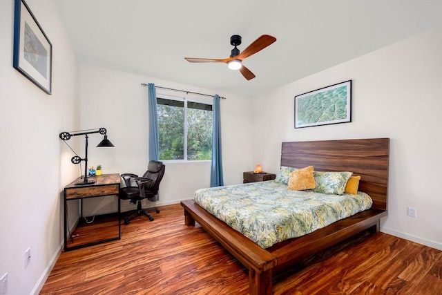 bedroom with baseboards and wood finished floors