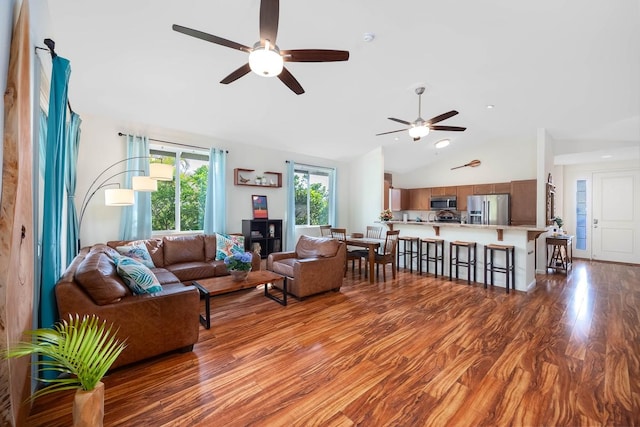 living area with a ceiling fan, recessed lighting, wood finished floors, and lofted ceiling