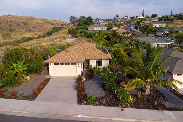 view of front facade with a garage, stucco siding, a residential view, and concrete driveway