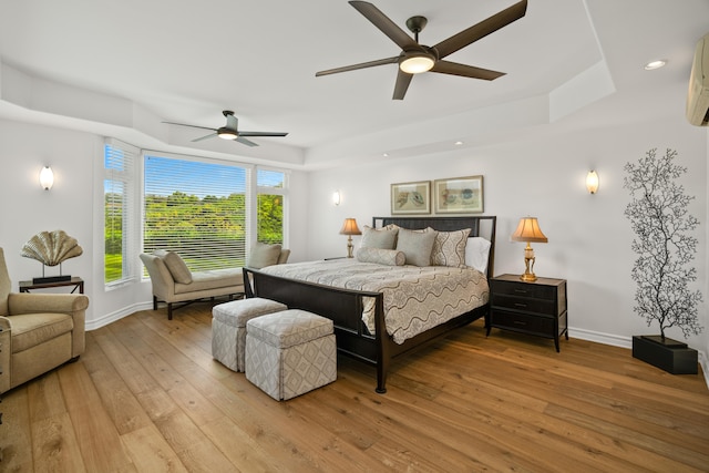 bedroom featuring baseboards, light wood-type flooring, recessed lighting, and a ceiling fan