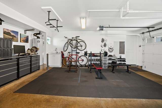 garage with electric panel, a garage door opener, and gas water heater