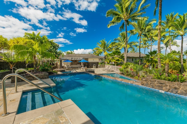 pool with fence and a patio area