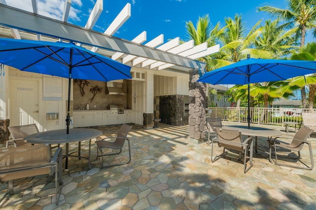 view of patio with a pergola, outdoor dining area, area for grilling, and fence