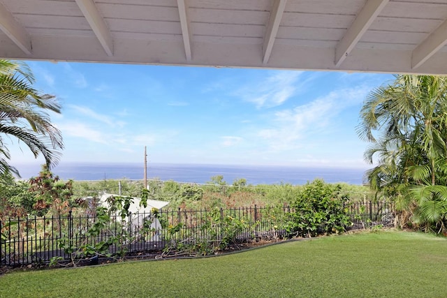 view of yard featuring a water view and fence
