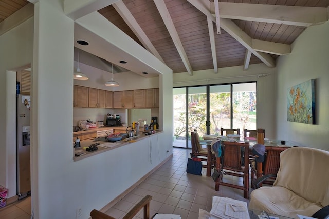 kitchen with lofted ceiling with beams, stainless steel fridge, and wood ceiling
