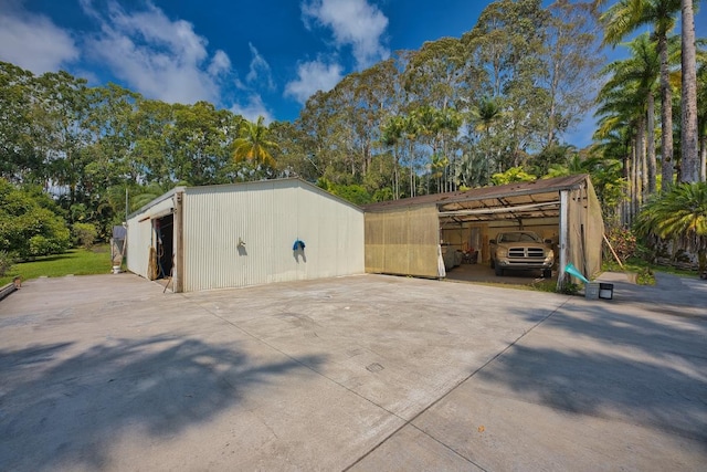 view of outbuilding featuring an outdoor structure and a detached carport