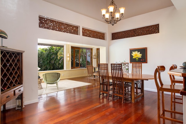 44-2325 Middle Rd, Honokaa, HI 96727 - dining space with a chandelier, a towering ceiling, baseboards, and wood finished floors