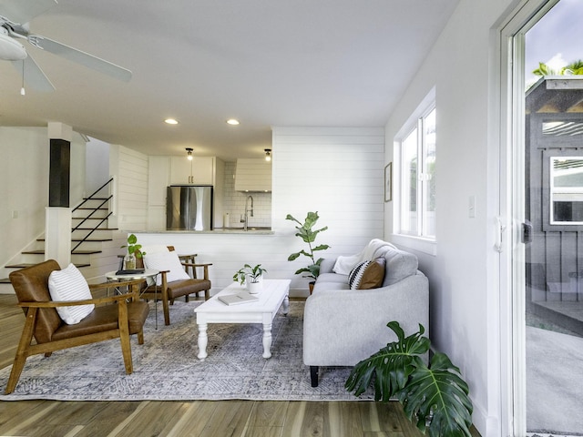 living area with recessed lighting, wood finished floors, stairway, and a ceiling fan