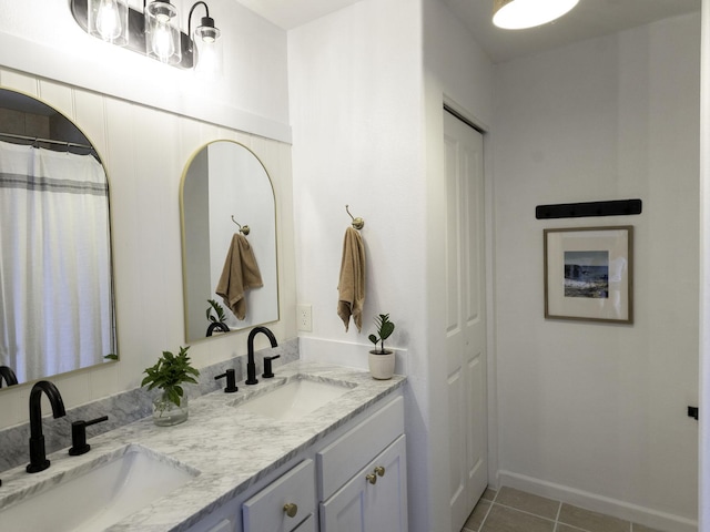 bathroom featuring double vanity, a sink, and tile patterned floors