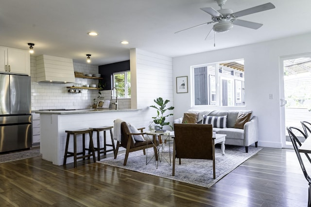 living room with baseboards, ceiling fan, recessed lighting, and dark wood finished floors
