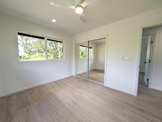 unfurnished bedroom with light wood-type flooring, baseboards, a closet, a ceiling fan, and recessed lighting