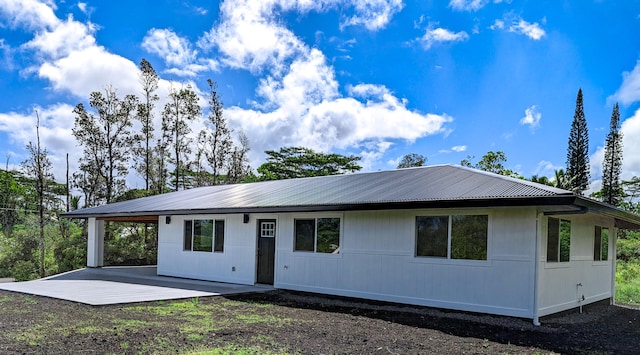 view of front of house with a patio and metal roof