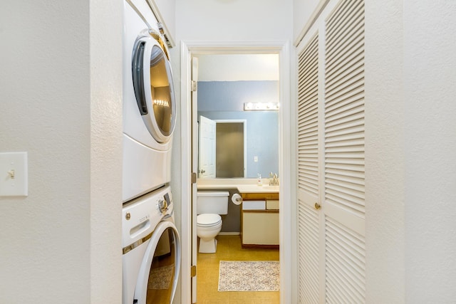 68-3890 Lua Kula St Unit 1601, Waikoloa, HI 96738 - washroom with stacked washer and clothes dryer and light floors