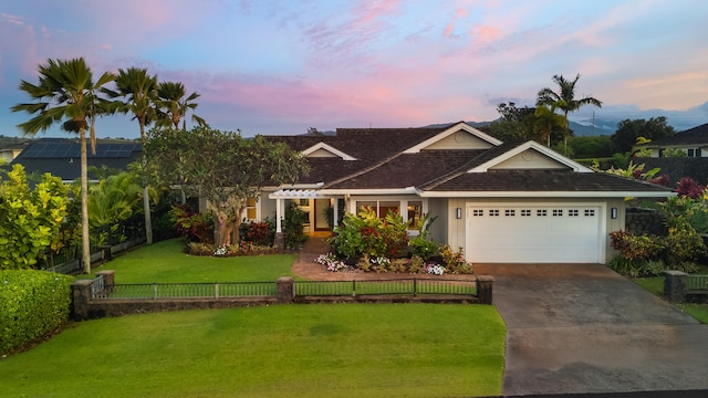 view of front of property featuring an attached garage, concrete driveway, and a shingled roof