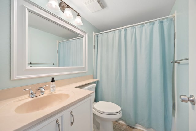 bathroom with toilet, vanity, tile patterned flooring, and a shower with curtain