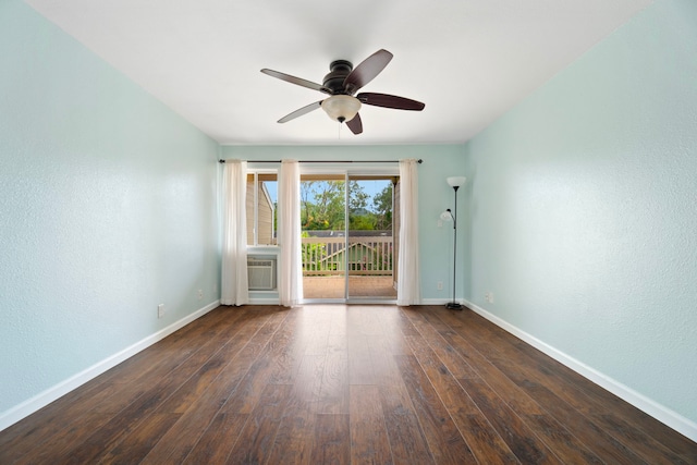 unfurnished room with baseboards, a ceiling fan, dark wood-style flooring, and a textured wall