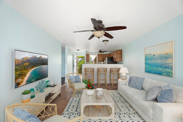 living room with ceiling fan and light wood-style floors