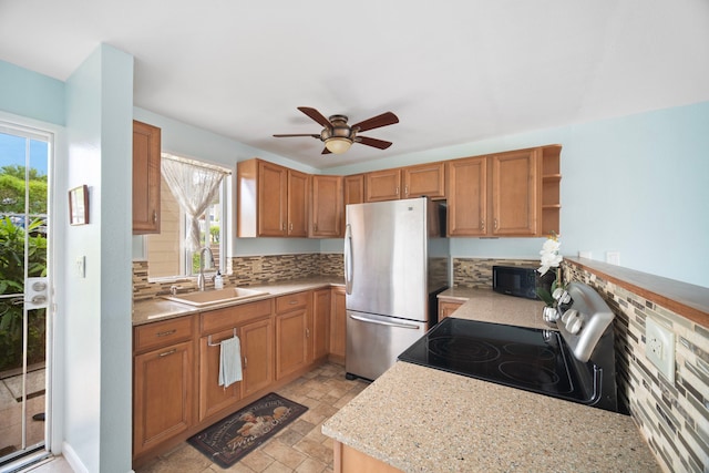 kitchen with appliances with stainless steel finishes, a sink, open shelves, a ceiling fan, and light stone finish flooring