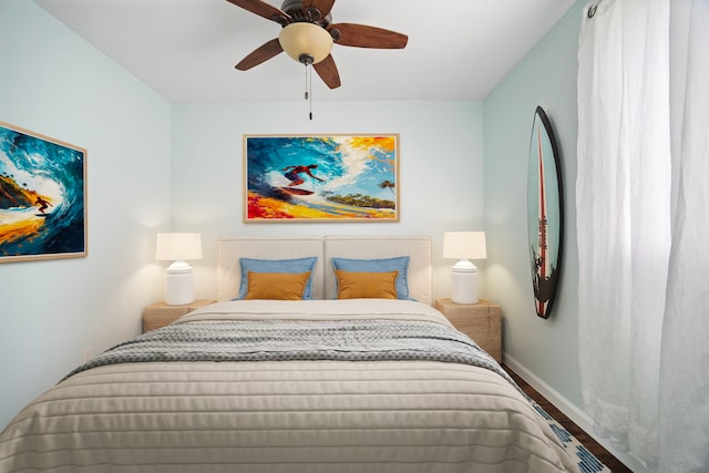 bedroom with wood finished floors, baseboards, and ceiling fan