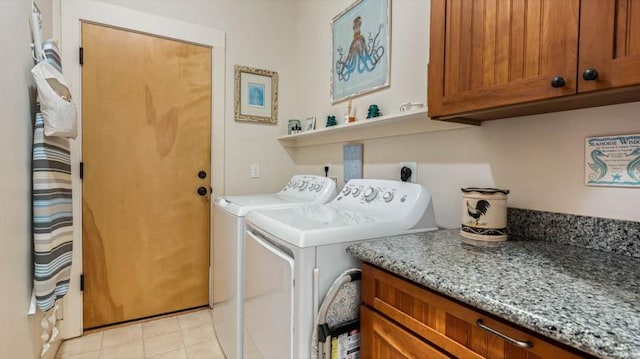 laundry room featuring independent washer and dryer and cabinet space