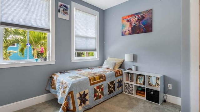 carpeted bedroom featuring baseboards